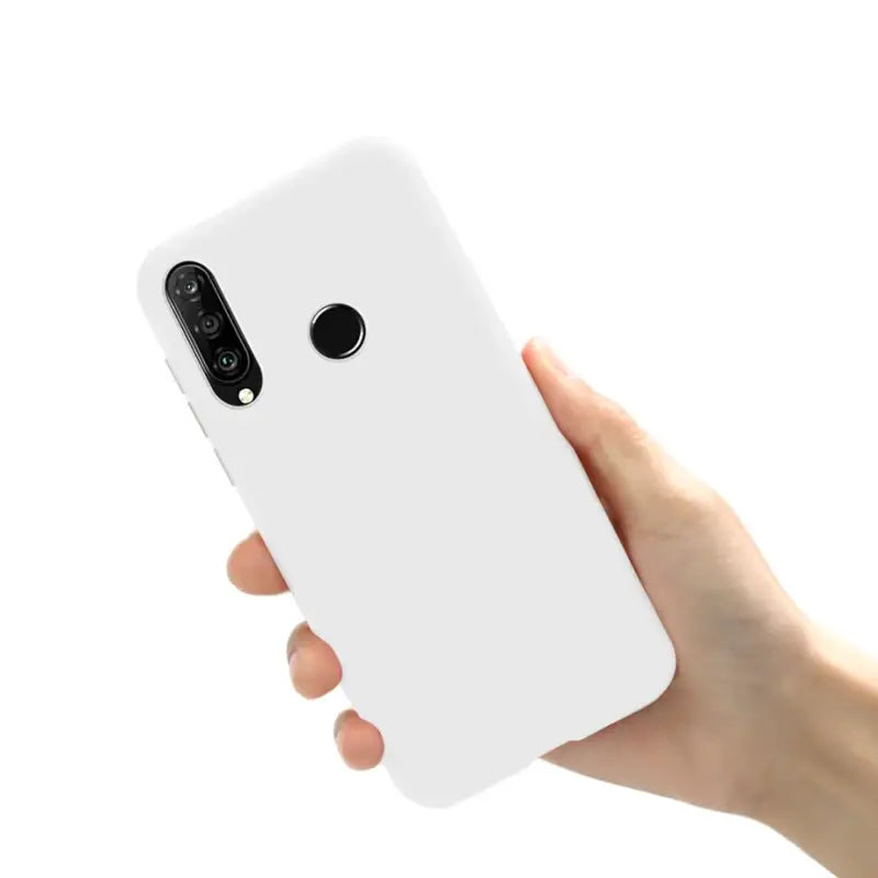 a hand holding a white phone case