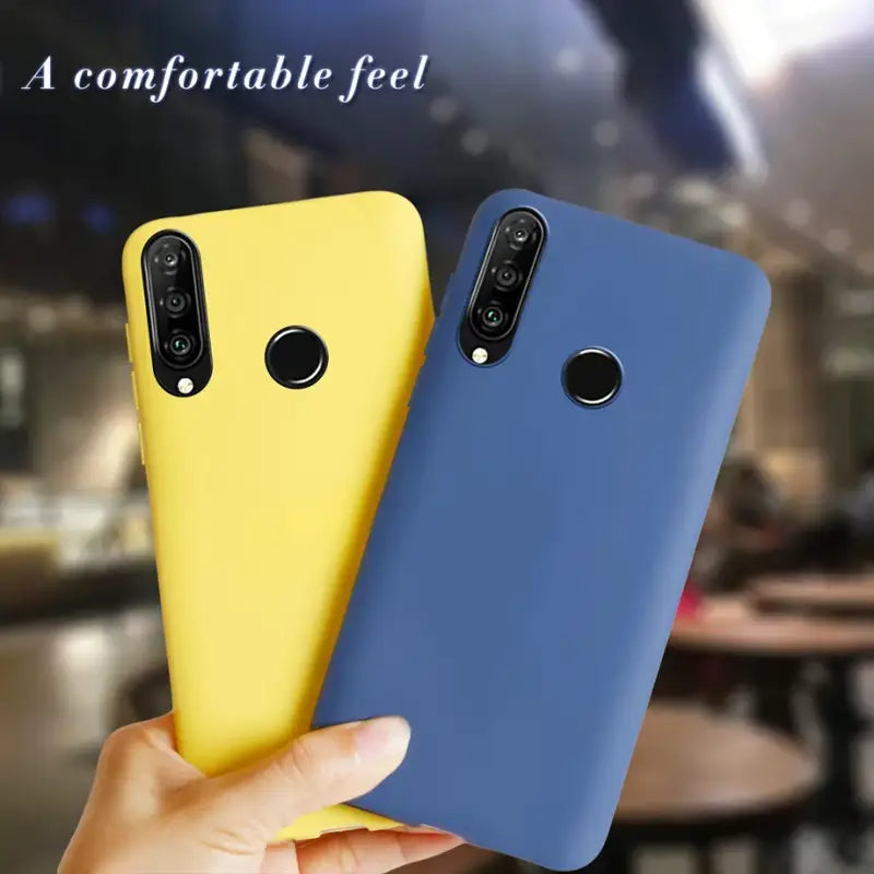 a hand holding a yellow and blue case for the xiao pixel