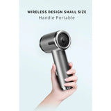 the hand held hair dryer is held in a hand