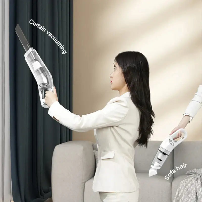 a woman in a white suit is holding a vacuum cleaner