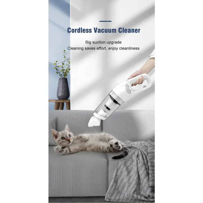 a cat laying on a couch with the cord vacuum cleaner