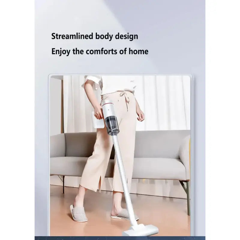 a woman standing on a floor with a vacuum cleaner