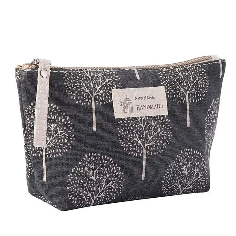 the small zipper bag is made from a black and white tree print