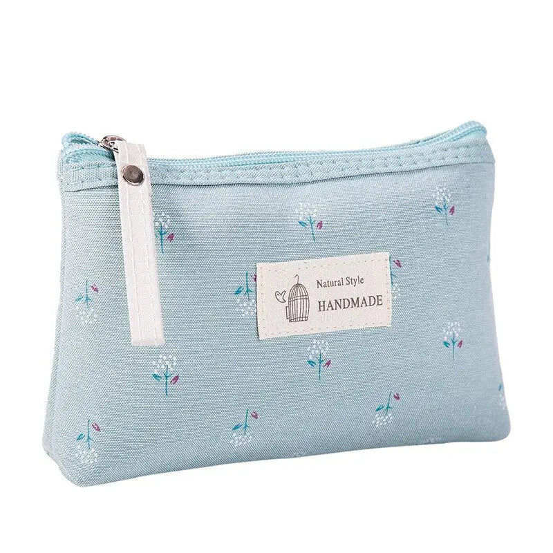 a small blue bag with a small white flower print