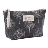 the small zipper bag is made from a black and white tree print