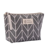 the small zipper bag is made from a grey and white geometric pattern