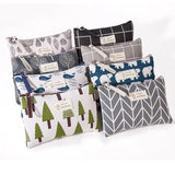a set of four small zipper bags with trees and mountains