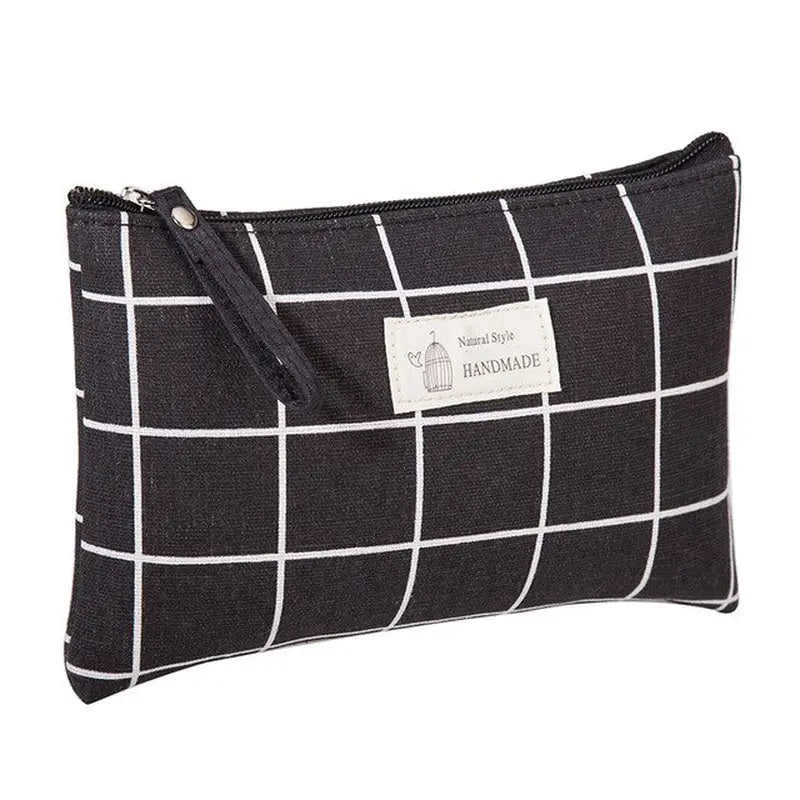 the black and white checkered pouch is shown with a zipper closure