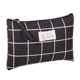 the black and white checkered pouch is shown with a zipper closure