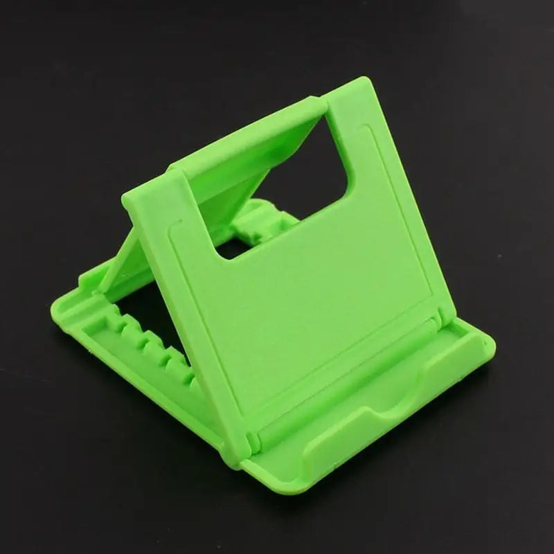 a green plastic phone holder on a black background