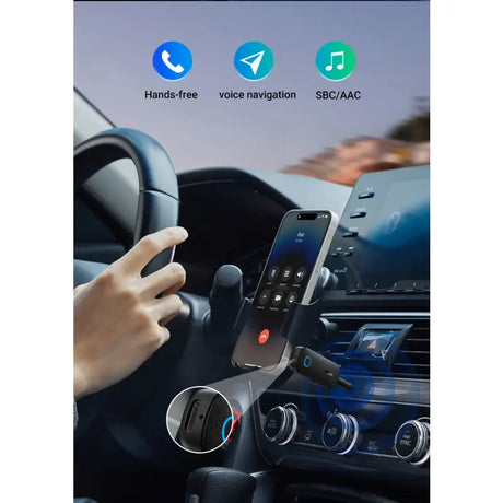 The hands are holding a phone in the car