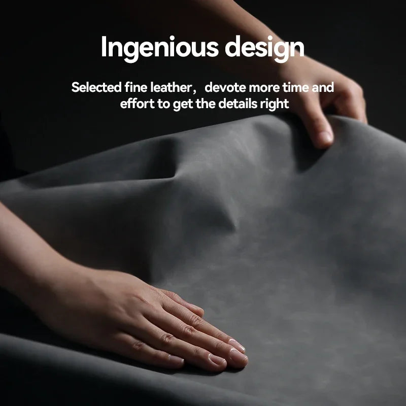 Hands demonstrating the pliability and texture of dark grey leather.