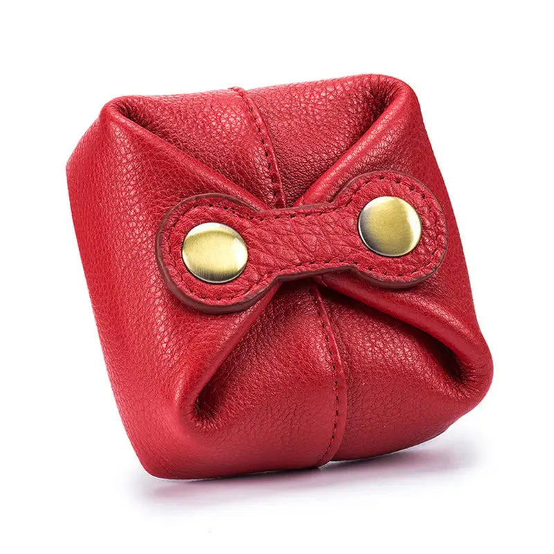 a red leather purse with a bow on the front