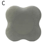 a gray foam coaster with a circular pattern