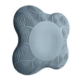 the grey foam cushion is made from foam and has a circular pattern
