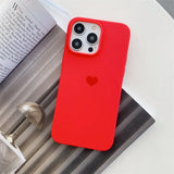 a red iphone case sitting on top of a book