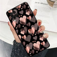 a woman holding a phone case with hearts on it