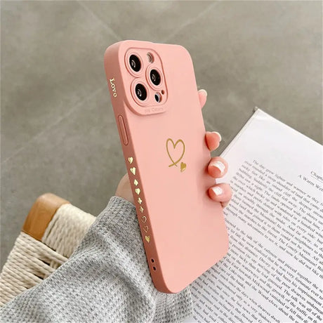 a pink iphone case with a heart on it