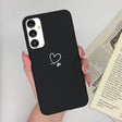 a woman holding a phone case with a heart on it