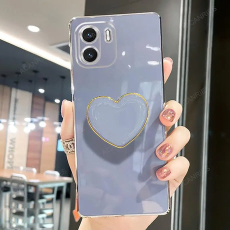 a woman holding a phone case with a heart on it