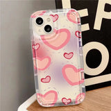 a pink heart pattern phone case on a table