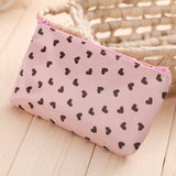 a pink and black heart print purse bag