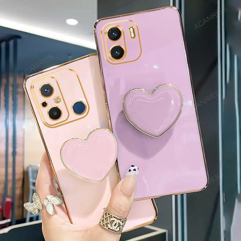 two phone cases with heart shaped rings