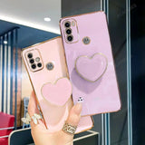 two heart shaped phone cases with a ring