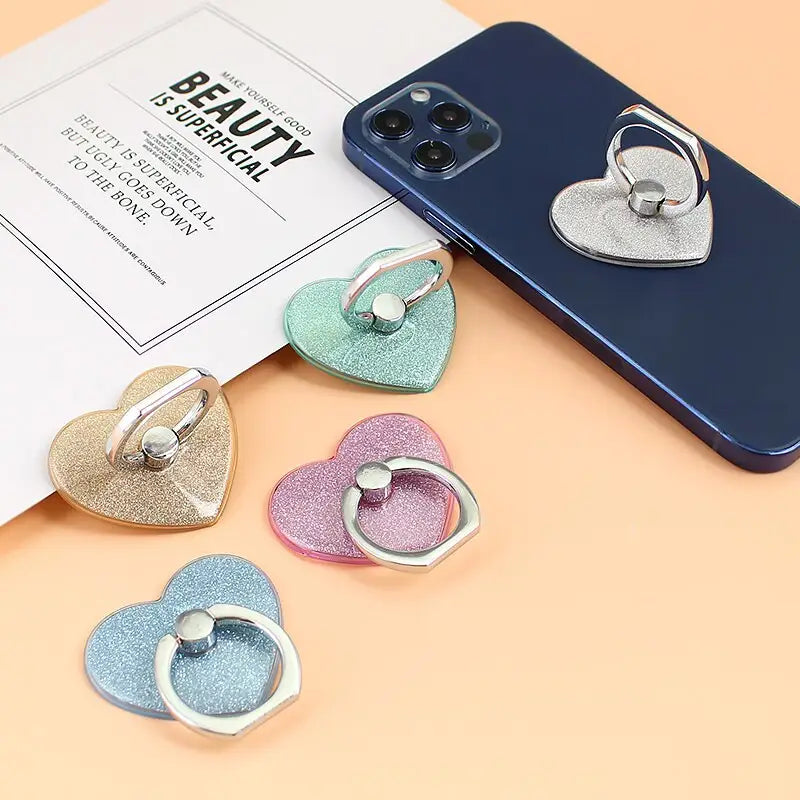 a phone case with three heart shaped charms