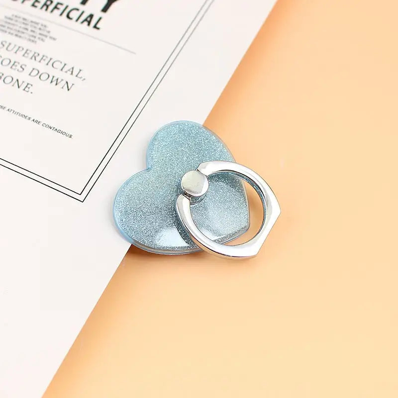 a heart shaped ring on top of a book