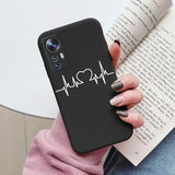 a woman holding a phone case with the heartbeat on it