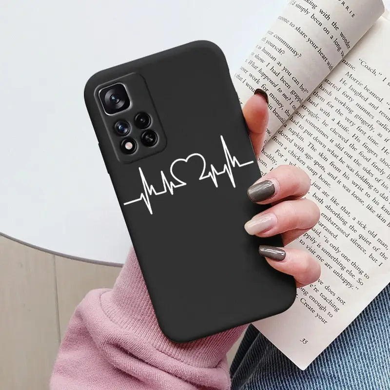 a woman holding a phone case with the heartbeat on it