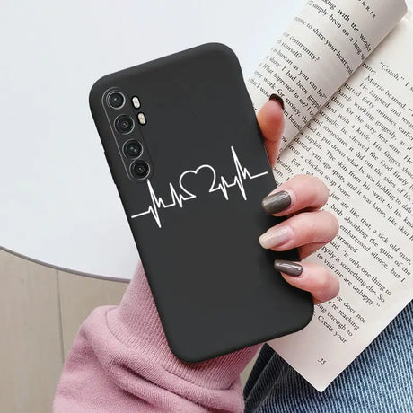 a woman holding a phone case with the heartbeat heartbeat