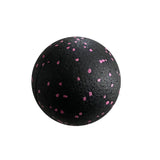 a black ball with pink spots on it