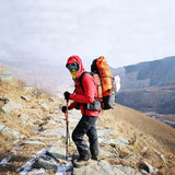 a man with a backpack is hiking up a mountain