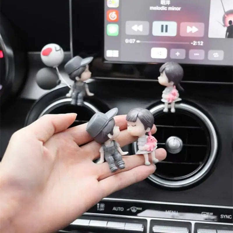 someone is holding a toy in their hand in a car