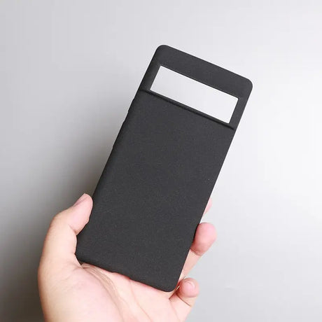 a hand holding a black card case