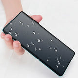 a hand holding a black iphone case with water droplets