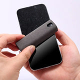 a person holding a black phone case