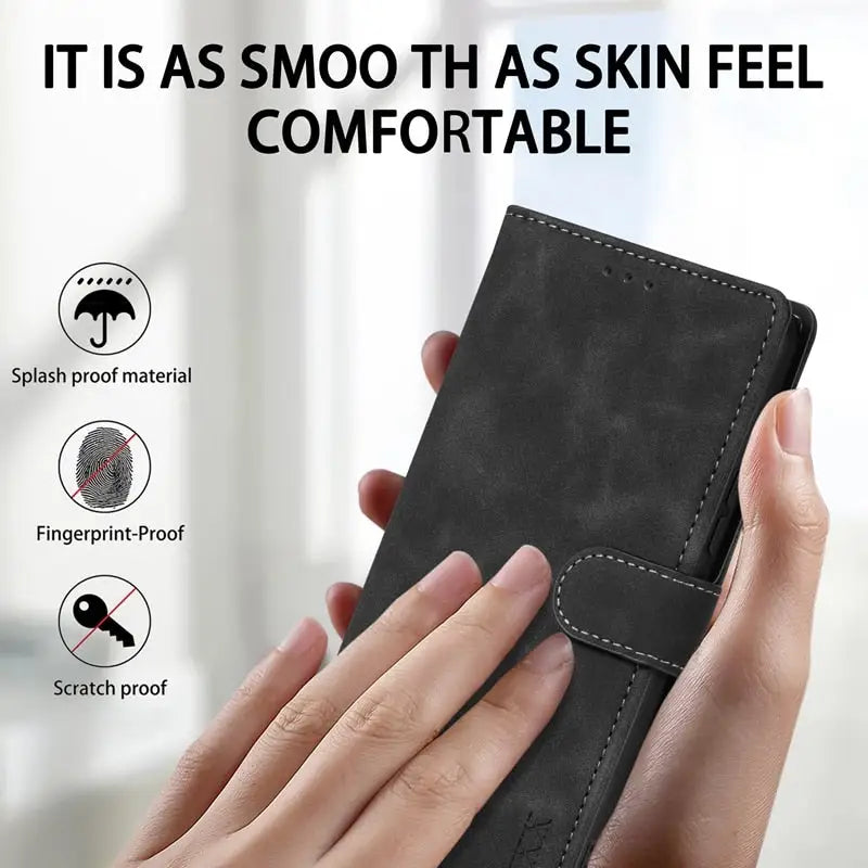 a hand holding a black leather wallet case