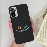 a person holding a phone case with a black cat face