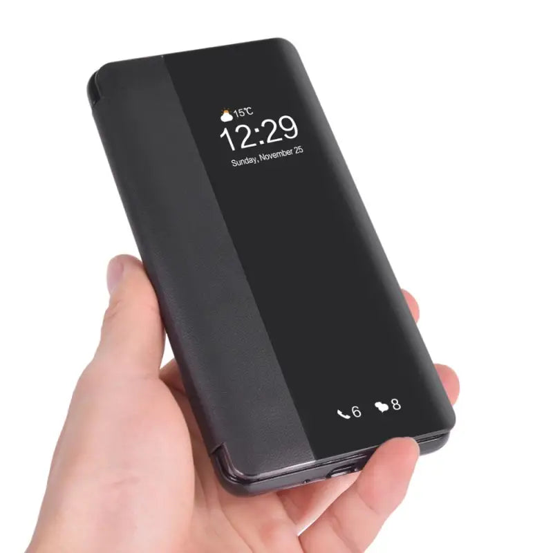 a hand holding a black power bank