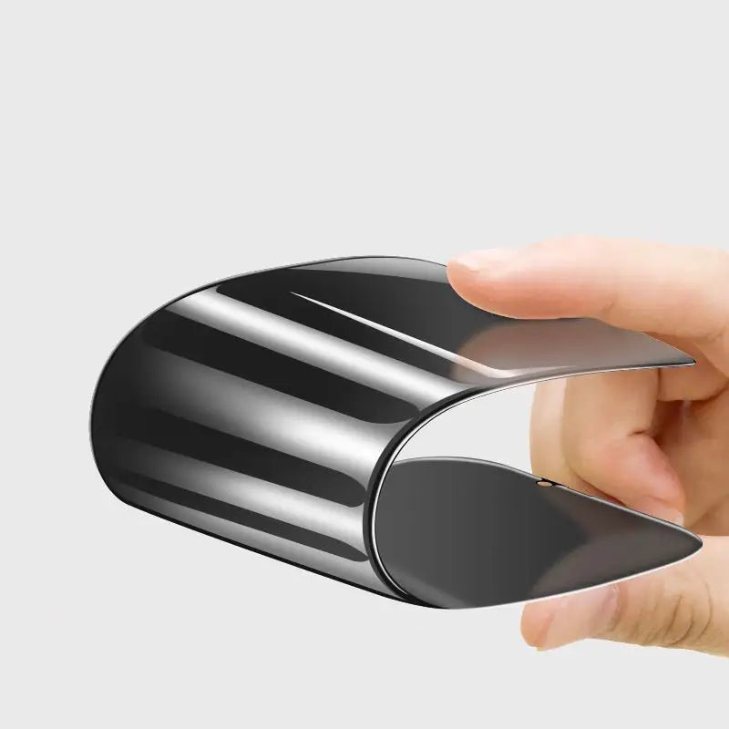 a hand holding a black and silver object