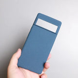 a hand holding a blue card case