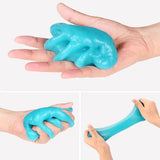 a hand holding a blue clay elephant