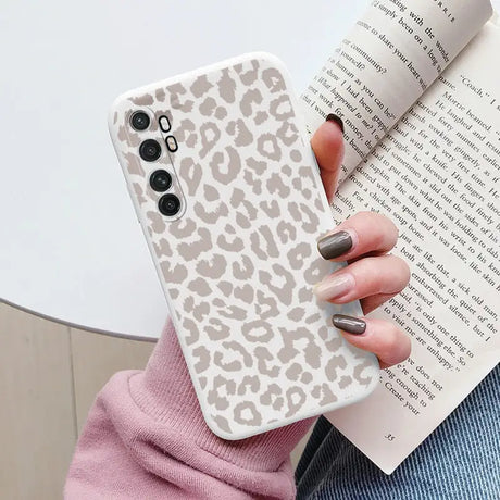 a woman holding a book and a phone case