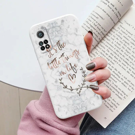 someone holding a phone case with a quote on it