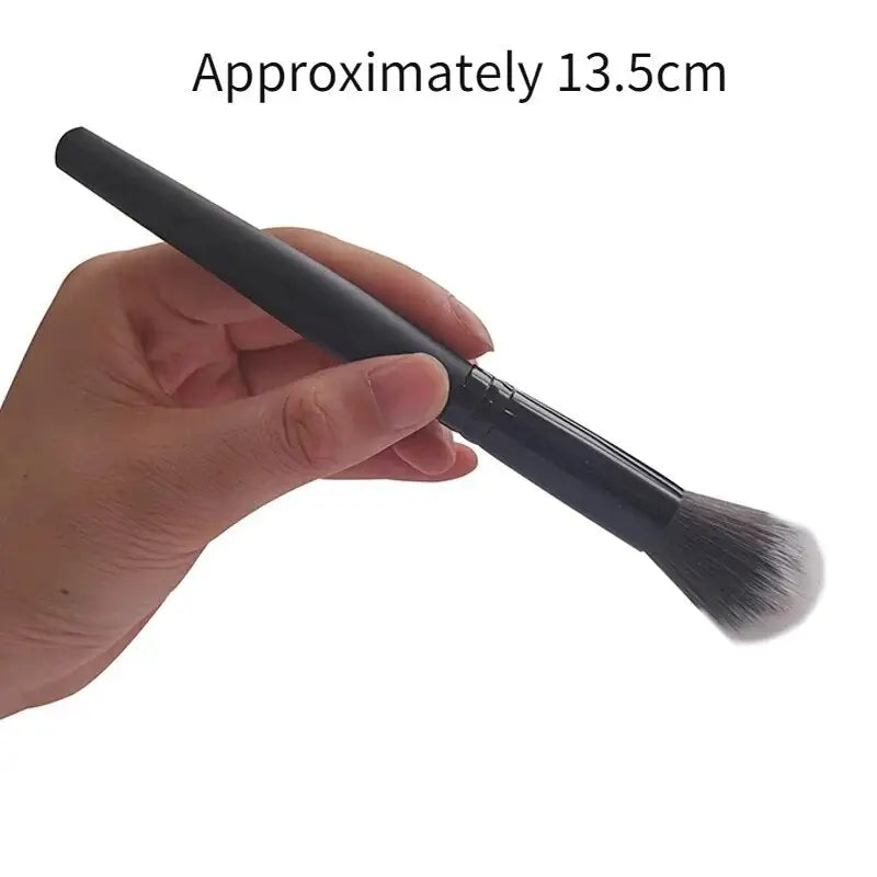 a hand holding a brush with the handle