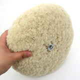 a hand holding a ball of wool