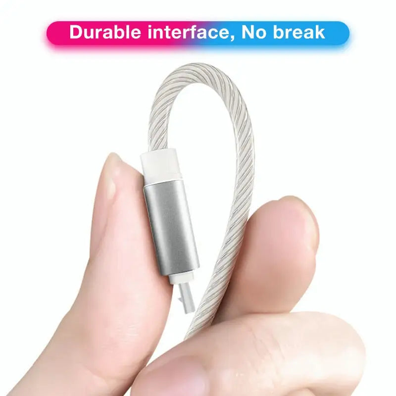 a hand holding a cable with a white cord